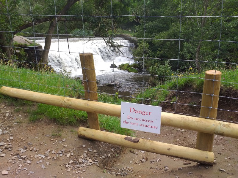Fencing sealing off access to the area beneath the weir in the Monsal valley