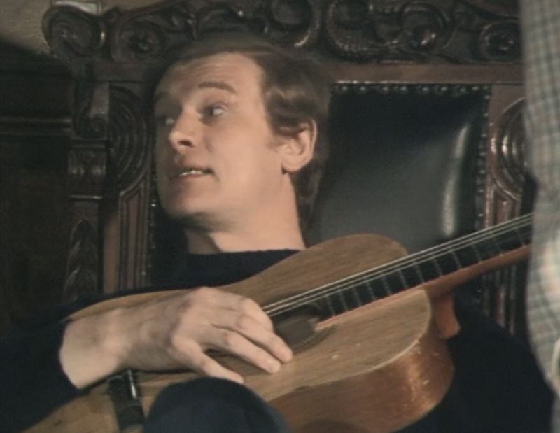 Greg strums guitar after the group enjoy a first meal together at The Grange