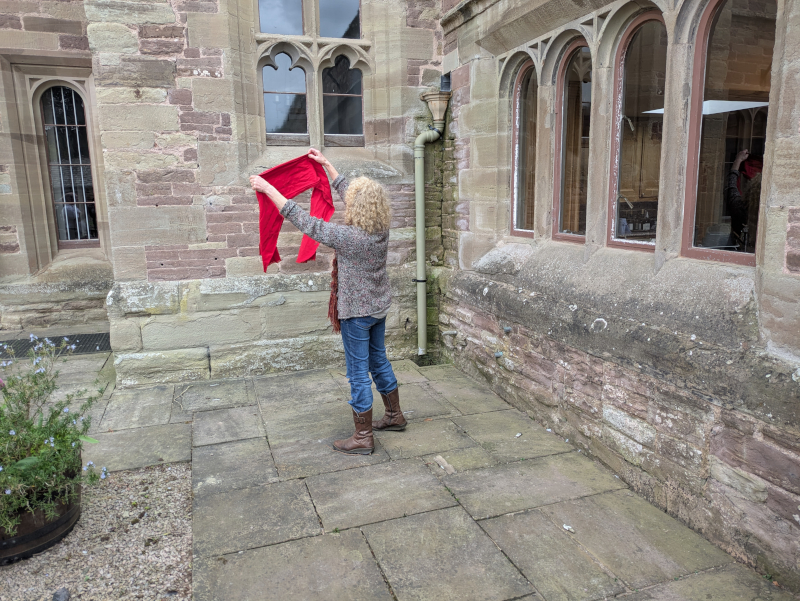 Julie Neubert re-enacts the moment from Spoil of War when Wendy hangs out the washing in the courtyard